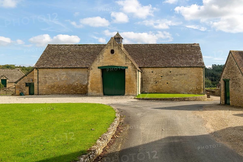 Historic nineteenth century farmyard stone barn building, Yanworth, Gloucestershire, England, UK