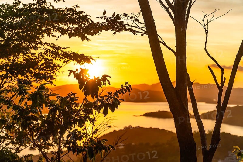 Majestic golden sunset illuminating the tranquil waters and lush islands surrounding coron, creating a breathtaking tropical paradise view