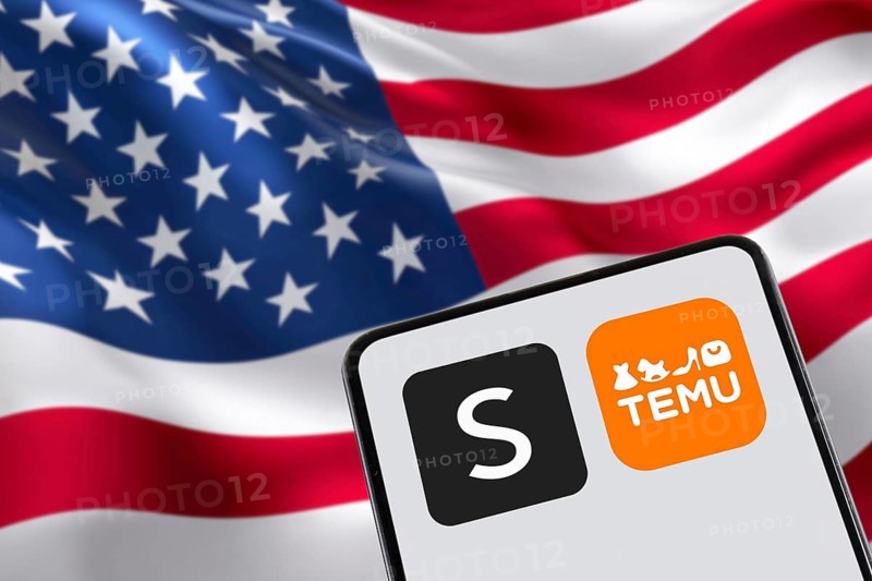 Temu and Shein app logo online marketplace from China with USA United States of America flag online commerce ecommerce on a mobile phone in Stuttgart, Germany, Europe