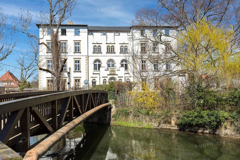 Park view of Lützschena Castle with castle bridge and White Elster, Leipzig, Saxony, Germany, Europe