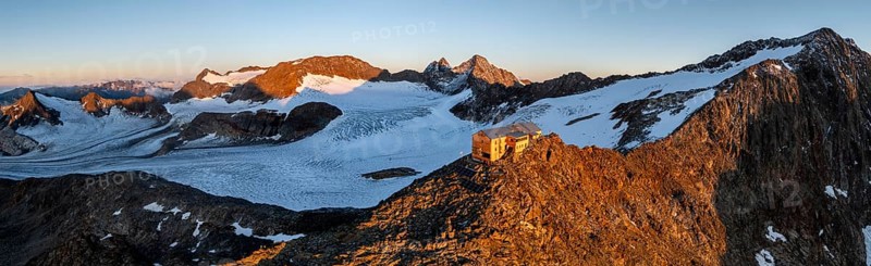 Atmospheric sunrise in a picturesque mountain landscape, alpenglow, aerial view, mountain hut Becherhaus at the summit Becher and glacier Übeltalferner, Stubai Alps, South Tyrol, Italy, Europe