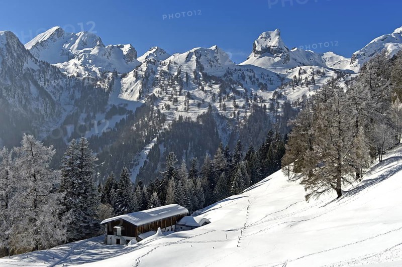 Winter view over the Loutse children's holiday home to the snow-covered Alpine peaks with Grand Chavalard, left, and Six Armaille, right, Ovronnaz, Valais, Switzerland, Europe