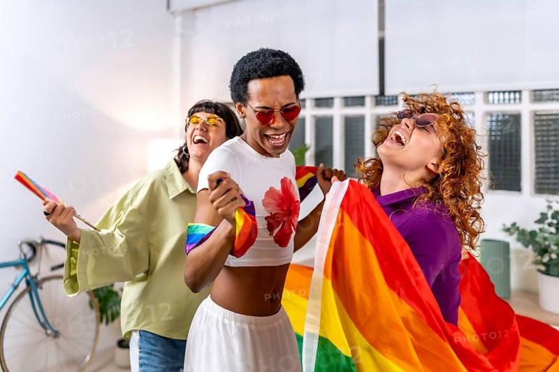 Happy multiracial and gender diverse lgbt people dancing an partying at home