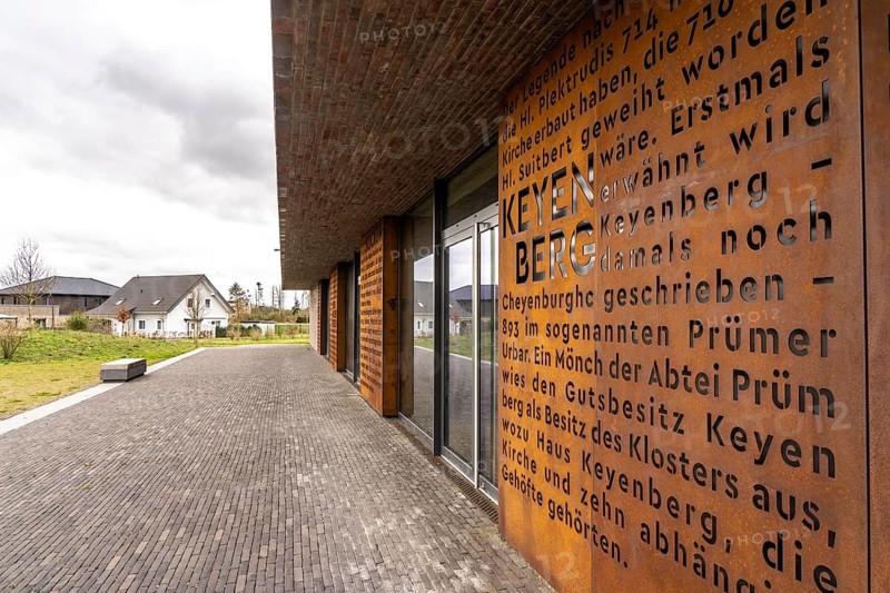 New multi-purpose hall, Keyenberg community centre, with Corten steel panels on the village history, in the resettlement site of the 5 villages from the Garzweiler II opencast lignite mining area, Keyenberg, Kuckum, Oberwestrich, Unterwestrich, Berverath, which were originally to be dug up but will now remain due to the lignite phase-out in 2030, around 60% of the former inhabitants of the villages live here in the new location on 56 hectares, in the north of Erkelenz, North Rhine-Westphalia, Germany, Europe