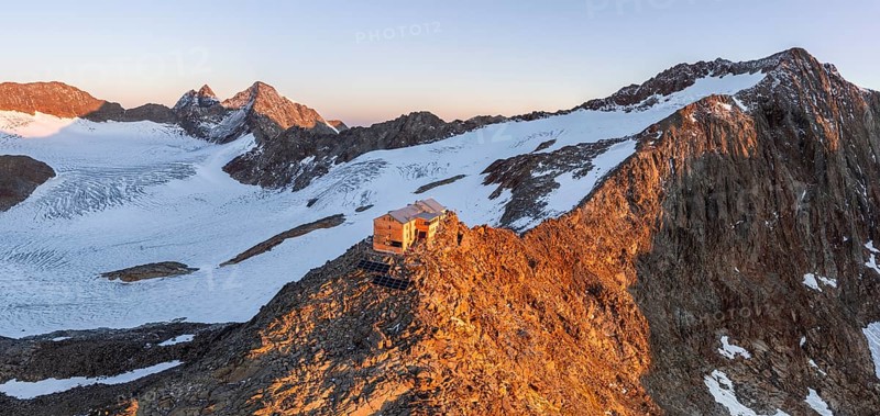 Atmospheric sunrise in a picturesque mountain landscape, alpenglow, aerial view, mountain hut Becherhaus at the summit Becher and glacier Übeltalferner, Stubai Alps, South Tyrol, Italy, Europe