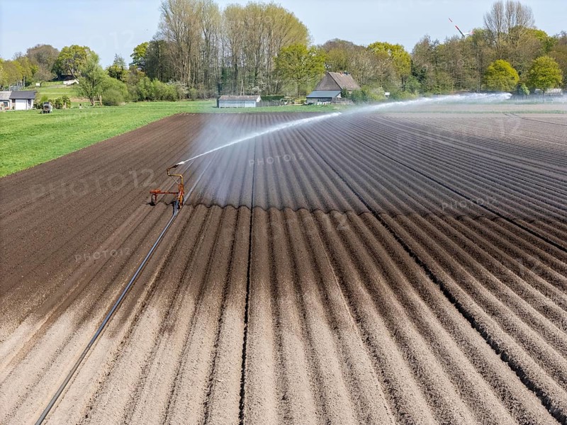 Artificial irrigation of a potato field in April, with a sprinkler system, long drought in spring makes this necessary, for the total of 7.5 hectares 3 full days are needed to get the necessary moisture for the freshly sown potato plants, south of Straelen, Lower Rhine, North Rhine-Westphalia, Germany, Europe