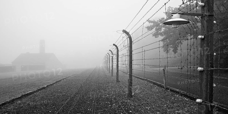 Reconstructed camp fence with crematorium in the fog at beech forest concentration camp, now a concentration camp memorial, Weimar, Thuringia, Germany, Europe