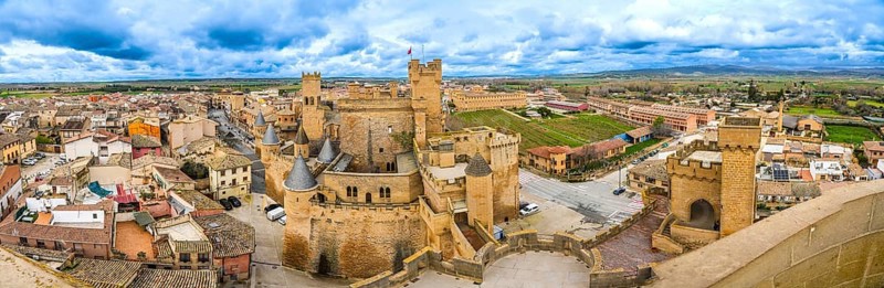 Panoramic view of the medieval royal palace of olite, a stunning example of gothic architecture, overlooking the picturesque town of olite in navarre, spain