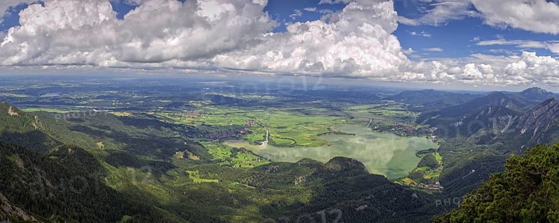 Panoramic view from Herzogstand down to a mountain landscape with Lake Kochel and cloudy sky, Kochel am See, Bavaria, Germany, Europe