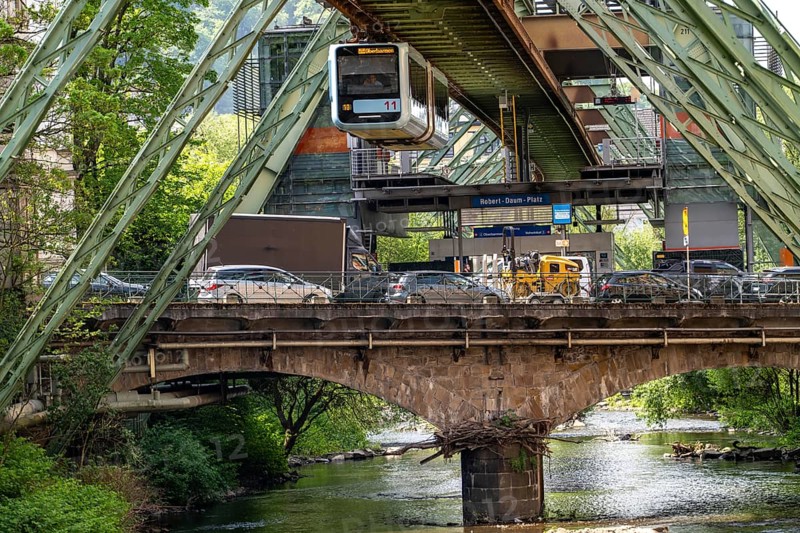 The Wuppertal suspension railway, train of the latest generation 15, floats above the Wupper, Robert-Daum-Platz station, North Rhine-Westphalia, Germany, Europe