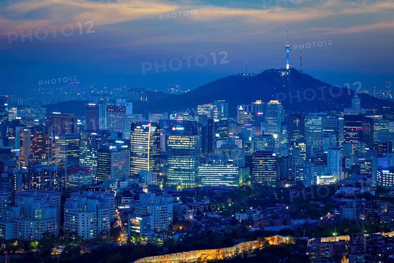 Seoul downtown cityscape illuminated with lights and Namsan Seoul Tower in the evening view from Inwang mountain. Seoul, South Korea, Asia