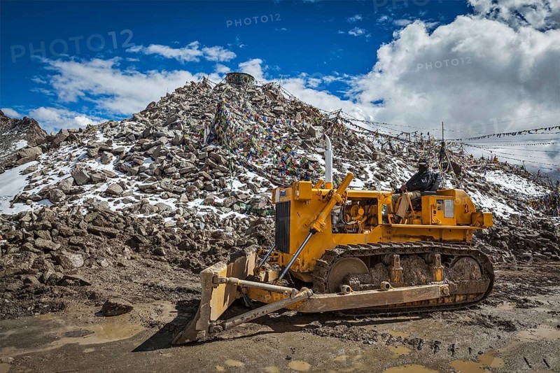 KHARDUNG LA PASS, INDIA, SEPTEMBER 12, 2012: Road construction at Kardung La, the highest motorable highest vehicle-accessible pass pass (5602 m) in the world. The pass is strategically important to India as it is used to carry supplies to the Siachen Glacier