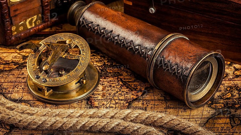 Travel geography navigation concept background, panorama of old vintage retro compass with sundial, spyglass and rope on ancient world map