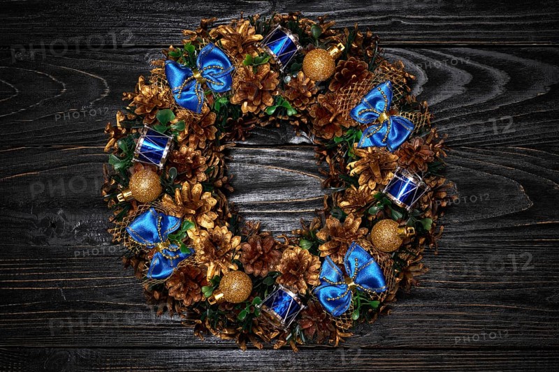 Christmas wreath on dark wooden background