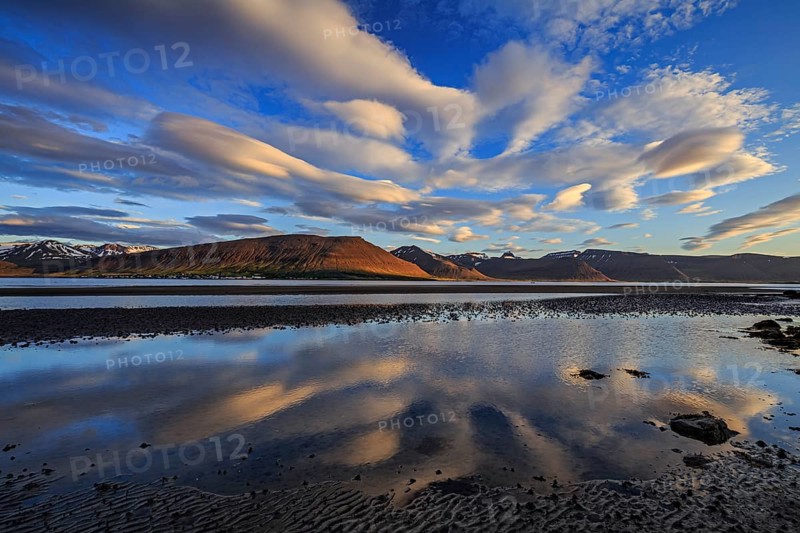 Ebb pond at a fjord off Bergen, evening light, clouds reflected in the water, Westfjords, Iceland, Europe