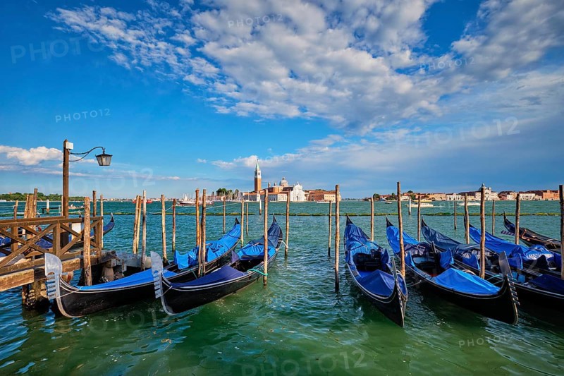 Gondolas and in lagoon of Venice by Saint Mark (San Marco) square with San Giorgio di Maggiore church in background in Venice, Italy, Europe