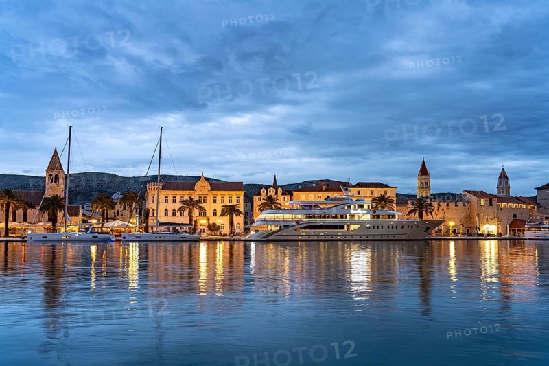 Cruise ship in front of the old town centre of Trogir at dusk, Croatia, Europe