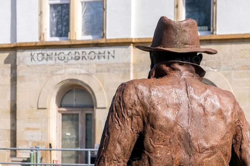 Georg Elser memorial at Königsbronn railway station. The statue by Friedrich Frankowitsch shows the resistance fighter Elser ready to travel with sticks of dynamite in his suitcase, waiting for a train on the Brenzbahn towards Munich. Königsbronn, Baden-Württemberg, Germany, Europe