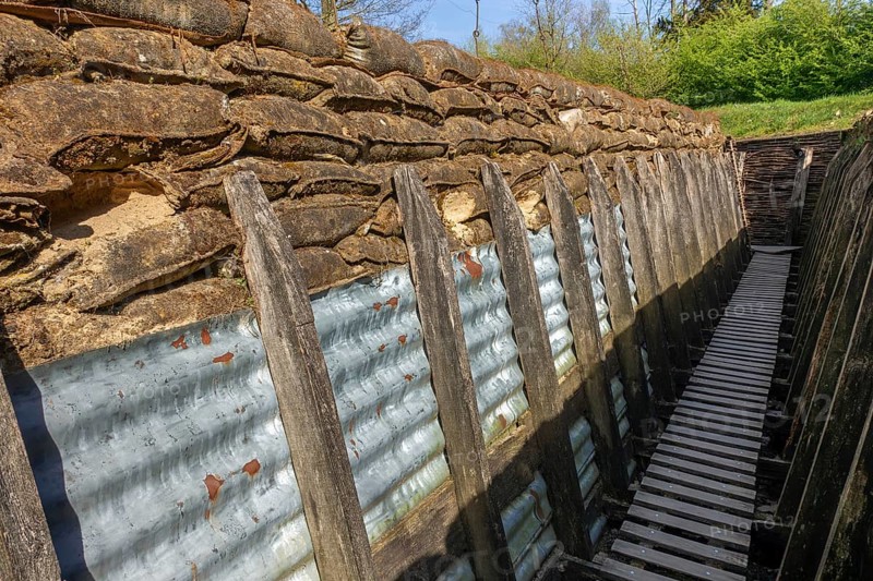 British WW1 trench showing wooden duckboards on A frames, sandbags and sheets of corrugated iron at the Passchendaele Museum, Zonnebeke, Belgium, Europe