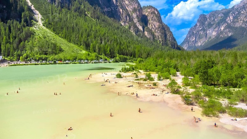 Tourists enjoying summer at lago di landro, also known as durrensee lake, surrounded by the stunning dolomites mountain range in trentino alto adige, italy