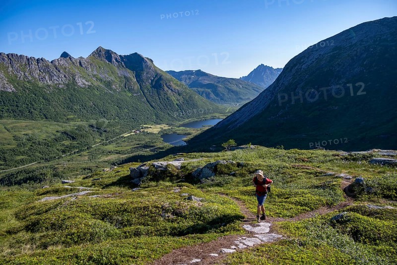 Mountaineers on a hiking trail to the summit of Rundfjellet, mountain landscape and valley with lakes, near Austnesfjord, Svolvaer, Nordland, Norway, Europe