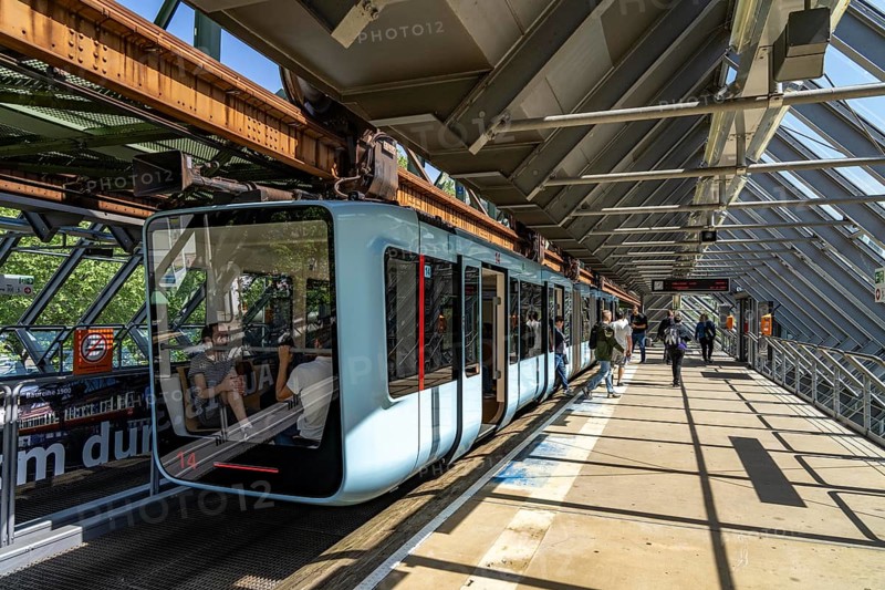 The Wuppertal suspension railway, train of the latest generation 15, floats above the Wupper, Wuppertal-Ohligsmühle station, North Rhine-Westphalia, Germany, Europe