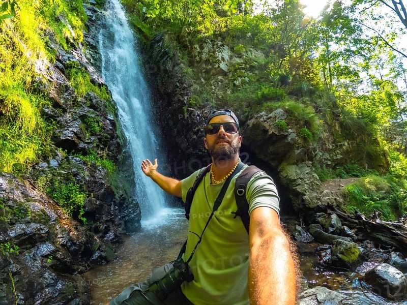 Man tourist hiker in summer at Todtnau waterfall in Black Forest in Germany