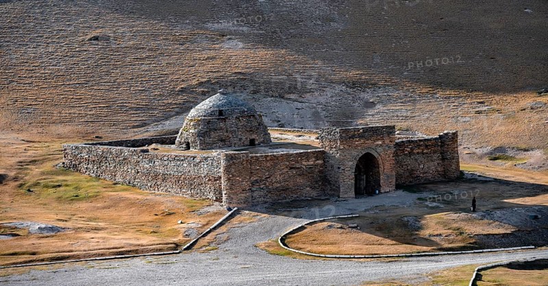 Historic caravanserai Tash Rabat from the 15th century, with yellow hills, Atbashy district in the Naryn region, Kyrgyzstan, Asia