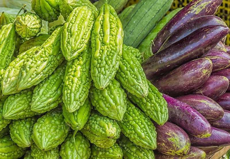 Fresh eggplant and momordica on the market