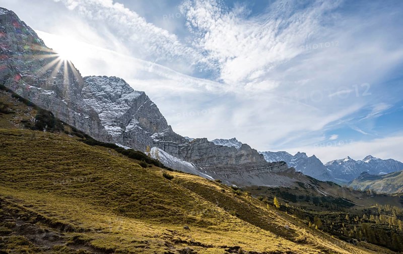 Mountain landscape with yellow meadows in autumn, summit Lamsenspitze with sun star, Karwendel, Tyrol, Austria, Europe