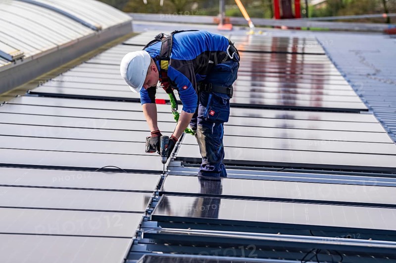 Installation of solar modules on the roof of a commercial enterprise, over 400 photovoltaic modules are installed on the roof, North Rhine-Westphalia, Germany, Europe