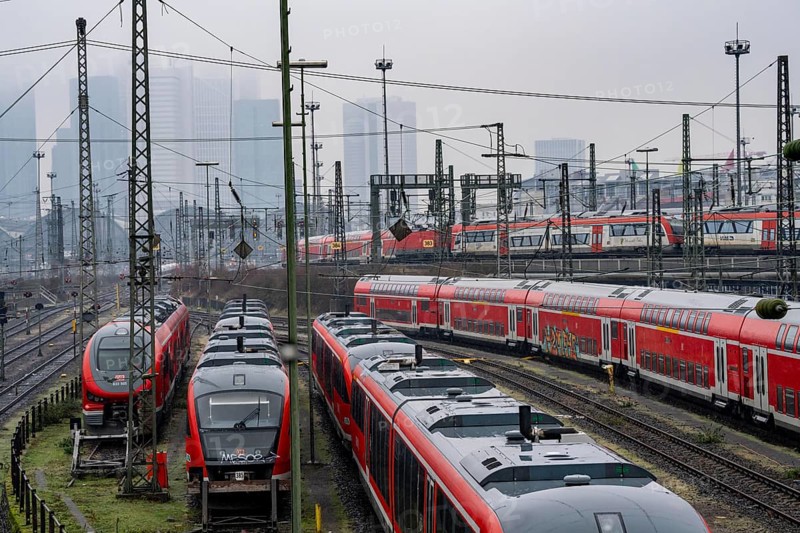 Railway tracks with regional trains, after freezing rain, in front of Frankfurt main station, skyline in the fog, Hesse, Germany, Europe