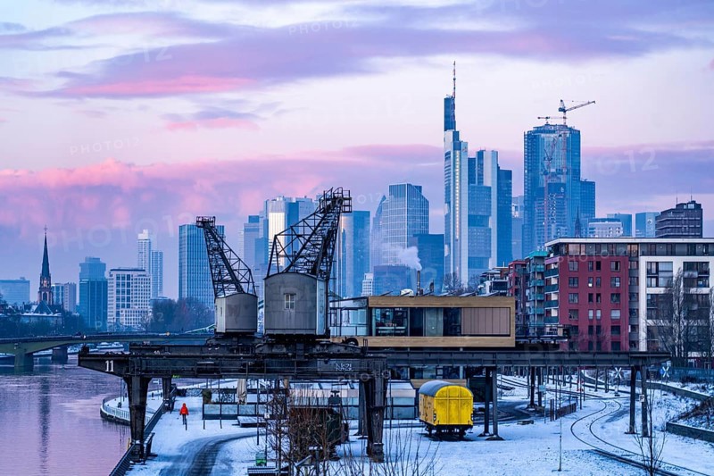 The skyline of Frankfurt am Main, skyscrapers of the banking district, historic harbour cranes at the Wesel shipyard, wintry morning, Hesse, Germany, Europe