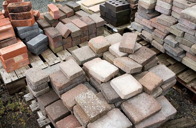 Clay bricks piled up in builder's yard, UK
