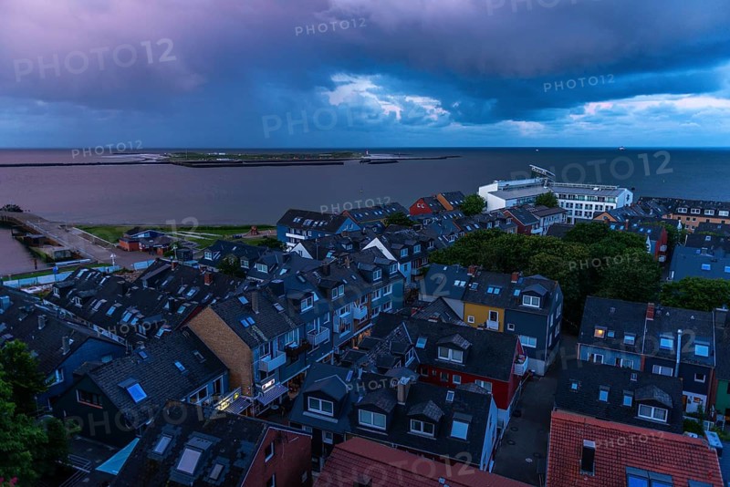 View from the upper land over the houses in the lower land to the Helgoland dune, Helgoland island, evening light, cloudy sky, North Sea, Pinneberg district, Schleswig-Holstein, Germany, Europe