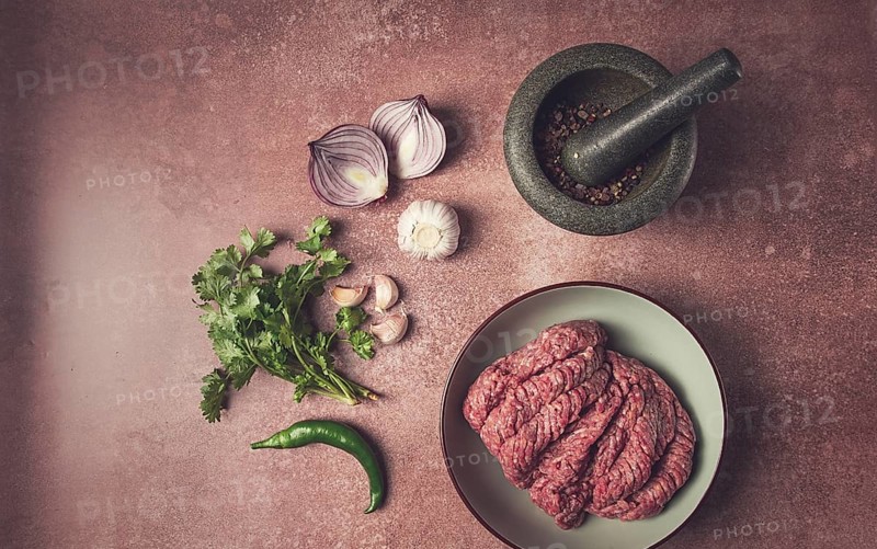 Fresh minced meat, raw, with spices and ingredients. on the table, preparation, top view
