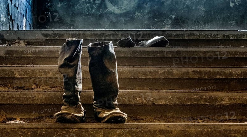 Old army boots, interior view of the former Alpine House on the historic grounds of the Tuberculosis Sanatorium in Beelitz, Brandenburg, Germany, Europe