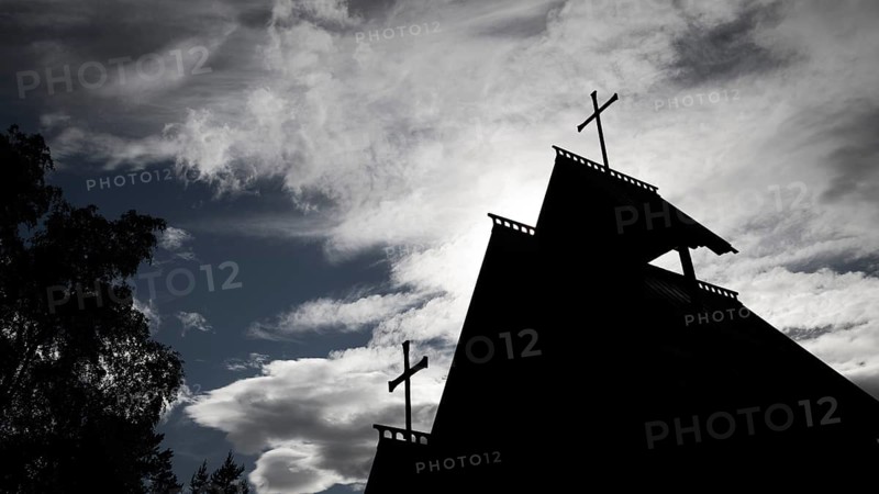 Silhouette of a church with two crosses against a dramatic cloudy sky, backdrop Kristin Lavranstochter film, Jørundgard Middelaldersenter, Olavsweg or Olavsleden, Sel municipality, Gudbrandsdalen, Norway, Europe