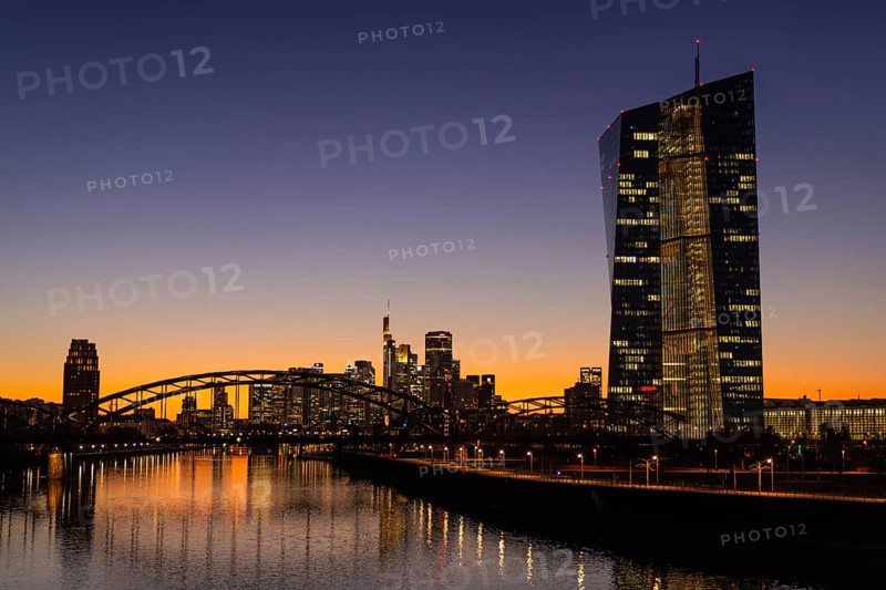 The lights in the offices of the European Central Bank (ECB) and the Frankfurt skyline glow in the evening after sunset, Osthafen, Frankfurt am Main, Hesse, Germany, Europe