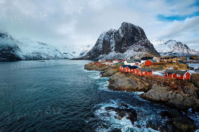 Hamnoy fishing village with red rorbu houses in Norwegian fjord in winter. Lofoten Islands, Norway, Europe