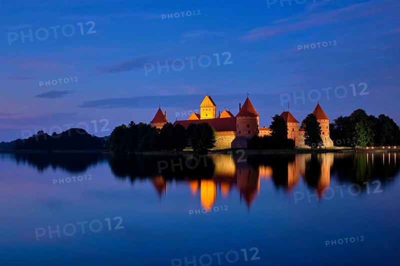 Evening view of Trakai Island Castle in lake Galve illuminated in the night, Lithuania, Europe
