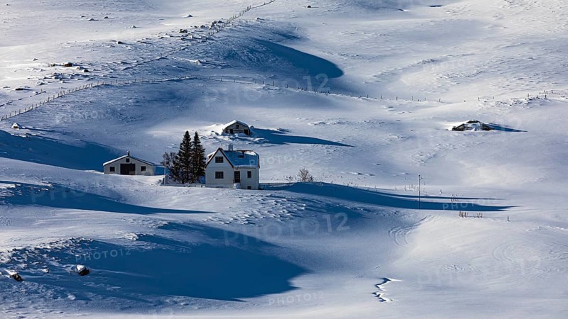 Farmhouse in snow-covered hilly landscape, near Akureyri, North Iceland Eyestra, Iceland, Europe