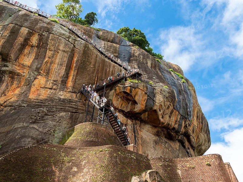 Visitors climb the stairs at Sigiriya Rock, Sri Lanka, Asia