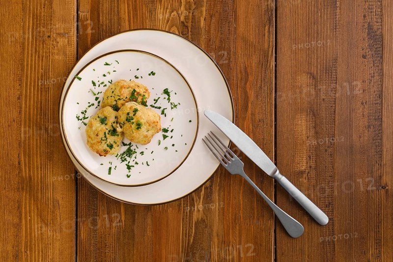 Top view of veal cutlets baked in oven on a plate