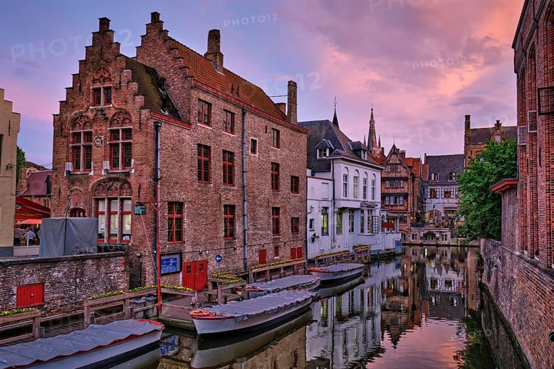 Bruges Rozenhoedkaai old houses along canal with tree in the evening. Famous place of Brugge, Belgium, Europe