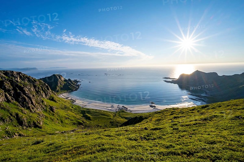 View of picturesque coastal landscape with sun star, Høyvika beach and sea, hike to the summit of Måtind, Andøya island, Vesterålen, Nordland, Norway, Europe