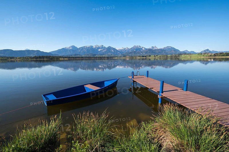 A blue jetty on a calm, clear lake with a breathtaking Alpine backdrop, Hopfen am See, near Füssen, Ostallgäu district, Swabia, Bavaria, Germany, Europe