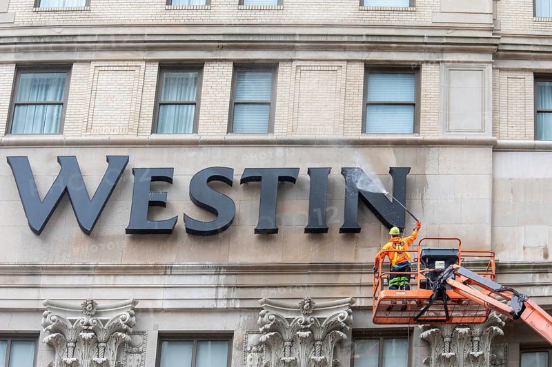 Detroit, Michigan - A worker uses a high-pressure water spray to clean the exterior of the 100-year-old Westin Book Cadillac Hotel