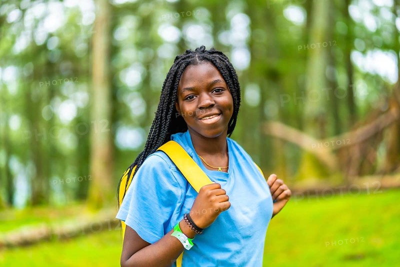 Horizontal close-up portrait of cheerful young african female hiker
