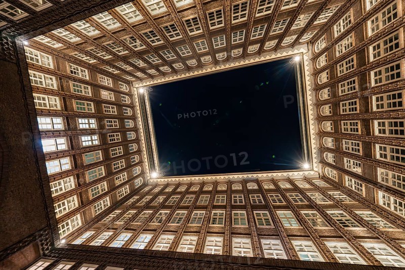 Impressive perspective of the Chilehaus at night, illuminated entrance and brick façade, Hamburg, Germany, Europe